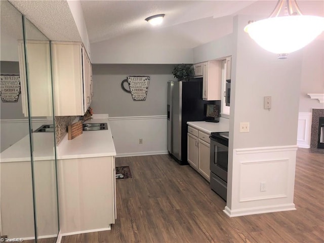 kitchen featuring vaulted ceiling, electric range oven, light countertops, and dark wood-style floors