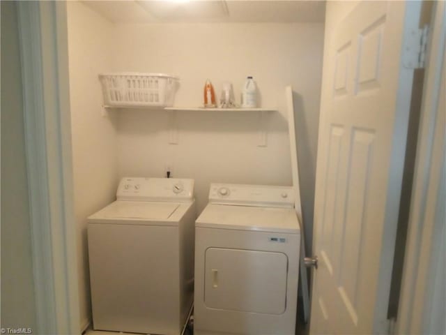clothes washing area with washer and clothes dryer and laundry area