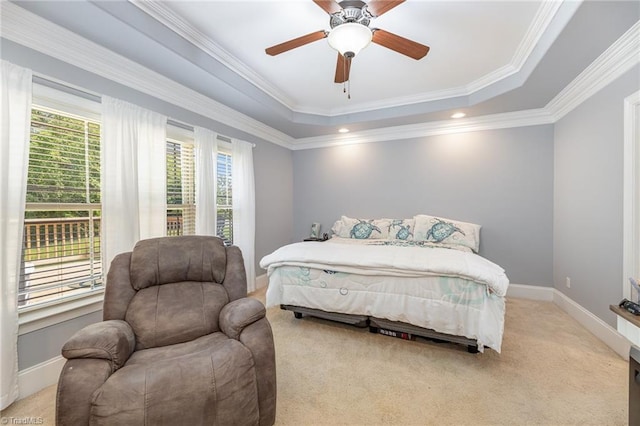 bedroom featuring crown molding, baseboards, light carpet, and a raised ceiling