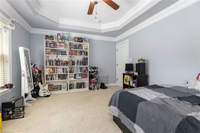 carpeted bedroom with crown molding, multiple windows, and a tray ceiling