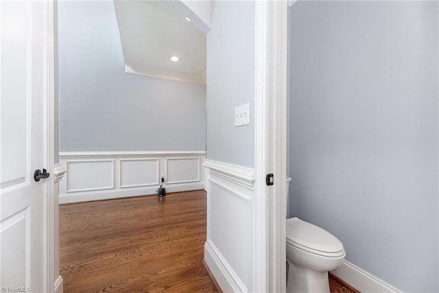 bathroom with recessed lighting, ornamental molding, wood finished floors, and toilet