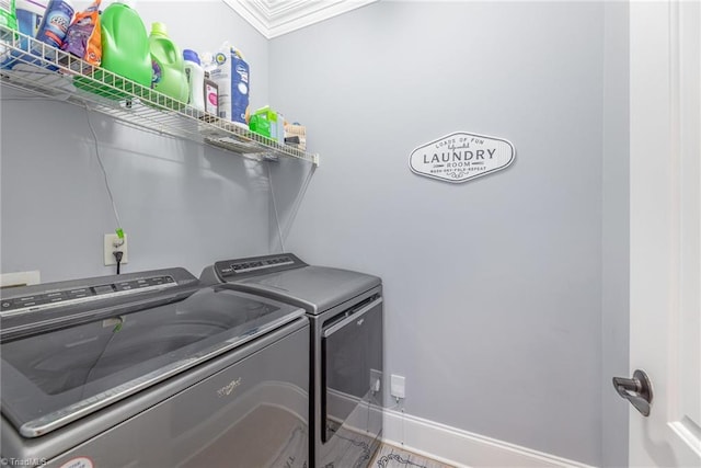 laundry room with laundry area, baseboards, and washing machine and dryer