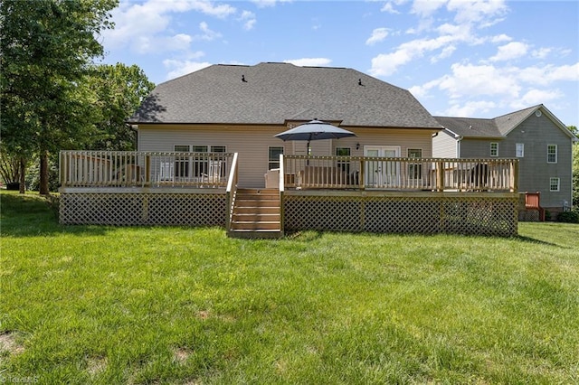 rear view of house with a lawn and a deck