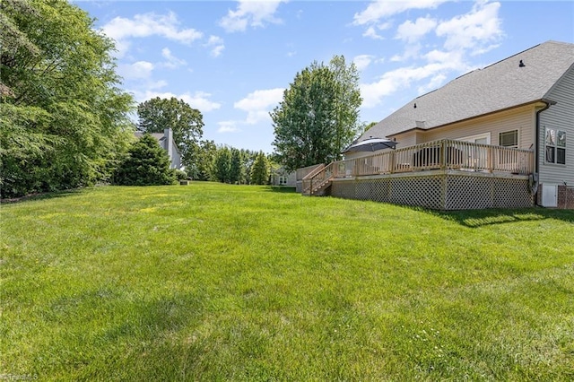 view of yard with a deck and central AC unit
