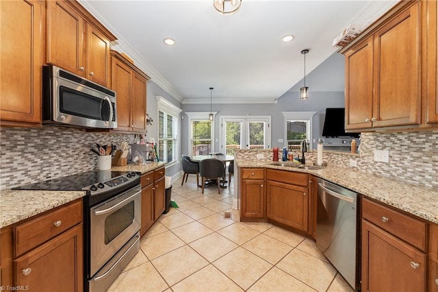 kitchen featuring a sink, appliances with stainless steel finishes, brown cabinets, and light tile patterned flooring