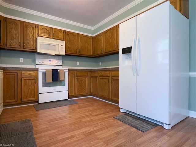 2065 Ardmore Village Ln, Winston-Salem, NC 27127 - kitchen with white appliances, ornamental molding, light wood-type flooring, and brown cabinets