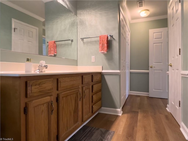2065 Ardmore Village Ln, Winston-Salem, NC 27127 - bathroom featuring crown molding, wood finished floors, vanity, and baseboards