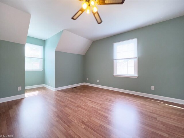 2065 Ardmore Village Ln, Winston-Salem, NC 27127 - bonus room with vaulted ceiling, wood finished floors, a ceiling fan, and baseboards
