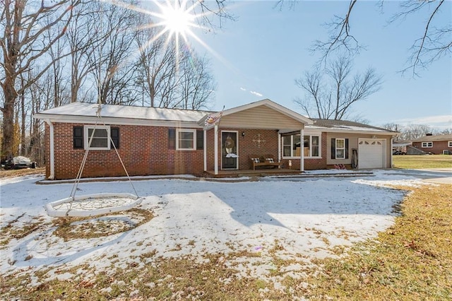 single story home featuring brick siding, an attached garage, and driveway