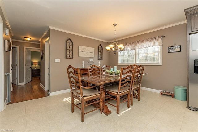 dining space featuring ornamental molding, baseboards, and a chandelier