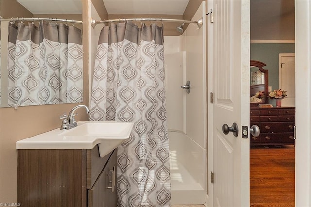 full bath featuring vanity, a shower with curtain, and wood finished floors