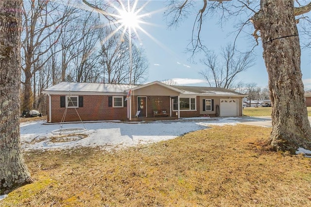 single story home featuring concrete driveway, brick siding, and a garage