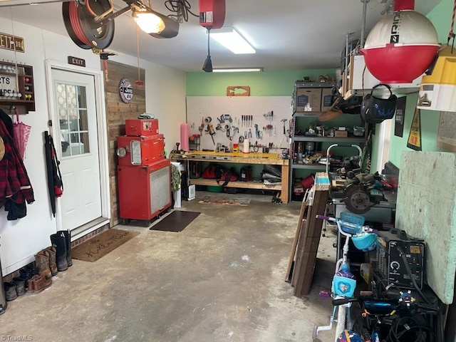 garage with a workshop area and a garage door opener