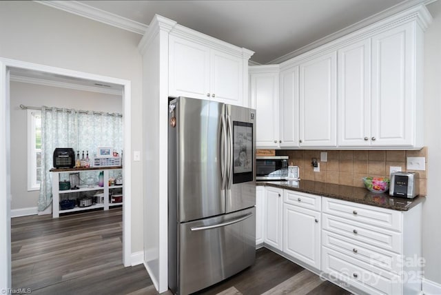 126 Strand Dr, New London, NC 28127 - kitchen featuring appliances with stainless steel finishes, dark wood-type flooring, tasteful backsplash, white cabinetry, and ornamental molding