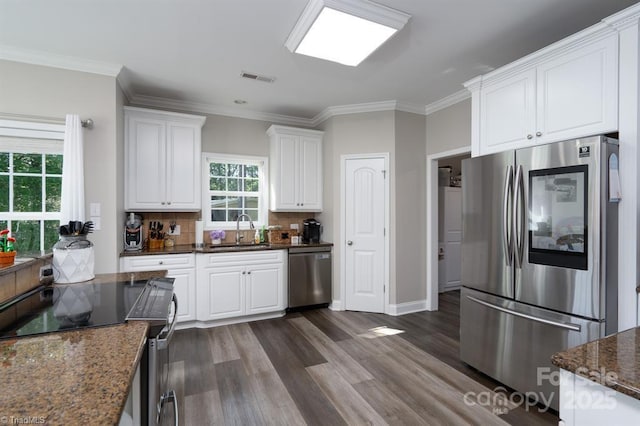 126 Strand Dr, New London, NC 28127 - kitchen with stainless steel appliances, a sink, white cabinetry, dark wood finished floors, and ornamental molding
