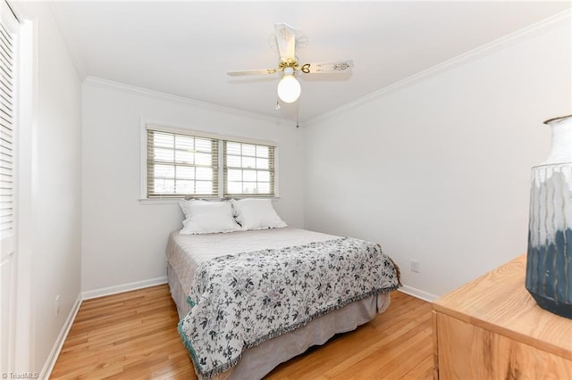 bedroom with hardwood / wood-style flooring, ornamental molding, and ceiling fan