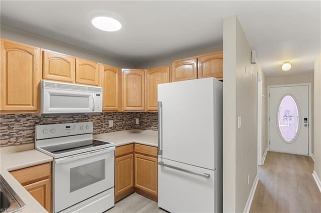 kitchen with light countertops, decorative backsplash, light wood-style floors, light brown cabinets, and white appliances