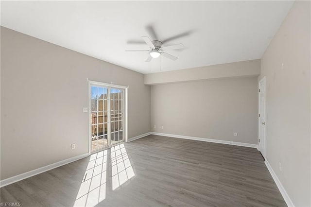 spare room with ceiling fan, baseboards, and wood finished floors