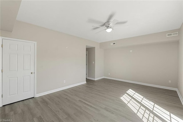 empty room featuring visible vents and wood finished floors