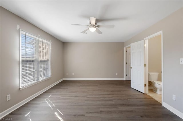 spare room with a ceiling fan, baseboards, and wood finished floors