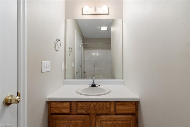 bathroom with walk in shower and vanity