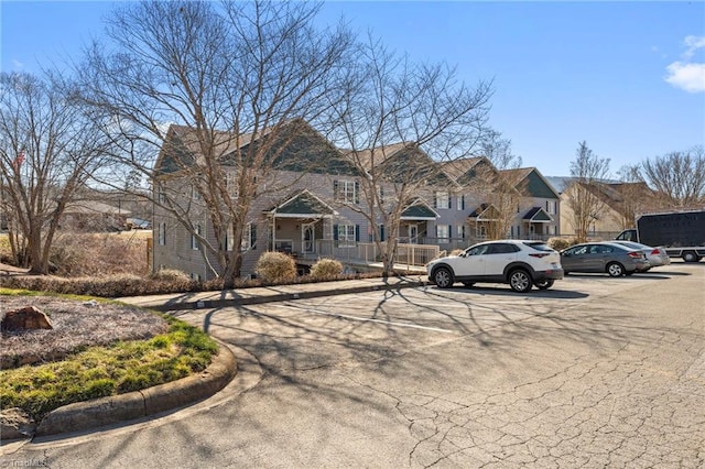 view of front of home featuring uncovered parking and a residential view