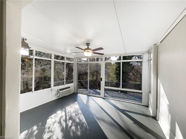 unfurnished sunroom with ceiling fan and a wall unit AC