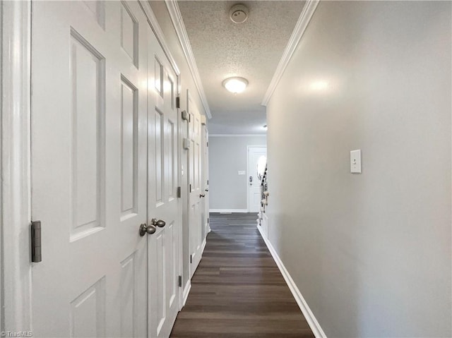 hall featuring a textured ceiling, dark hardwood / wood-style flooring, and ornamental molding