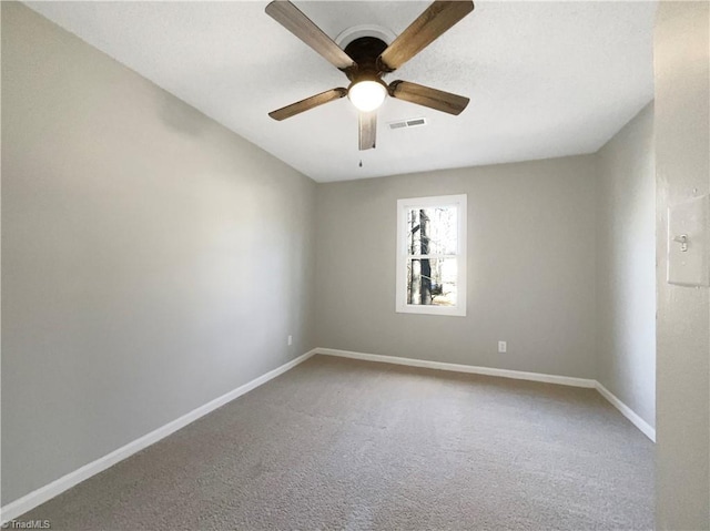 carpeted spare room featuring ceiling fan