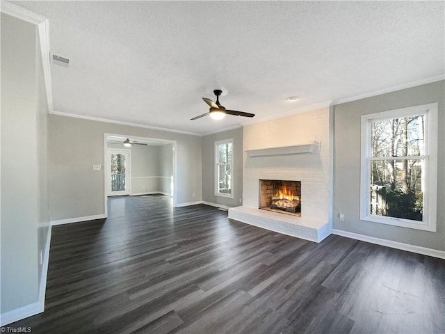 unfurnished living room with dark hardwood / wood-style floors, ceiling fan, a healthy amount of sunlight, and a fireplace