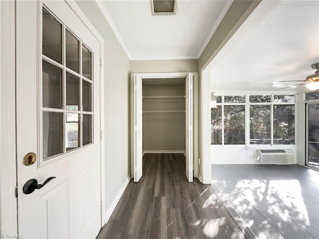 corridor featuring plenty of natural light, crown molding, an AC wall unit, and dark hardwood / wood-style flooring