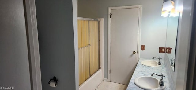 bathroom with bath / shower combo with glass door and vanity