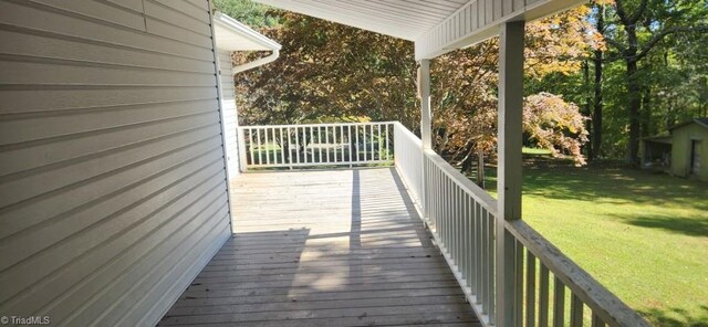 wooden terrace with a yard