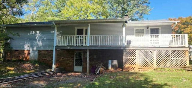 rear view of property featuring a balcony