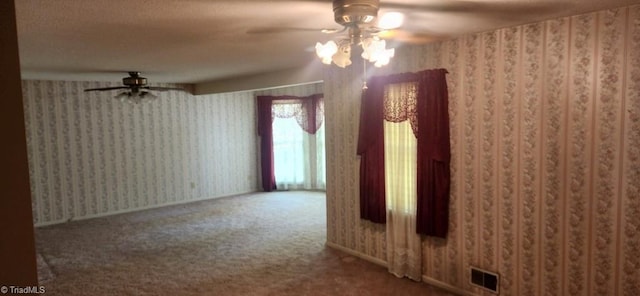 empty room featuring ceiling fan and carpet flooring