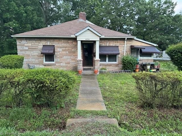 429 Jeffries St, Burlington, NC 27217 - bungalow-style house with a chimney, stone siding, a shingled roof, and a front lawn