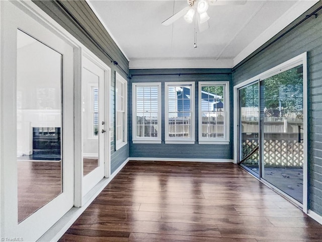 unfurnished sunroom with ceiling fan