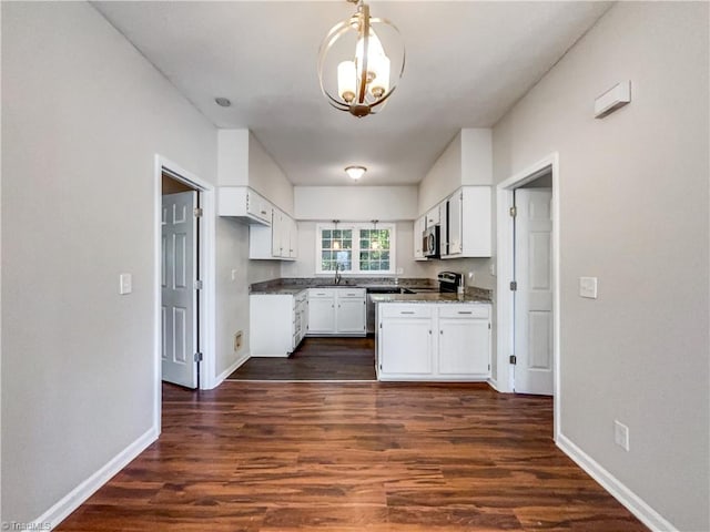 kitchen with dark wood-type flooring, white cabinetry, and sink