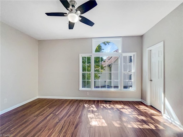 unfurnished room featuring dark hardwood / wood-style flooring and ceiling fan