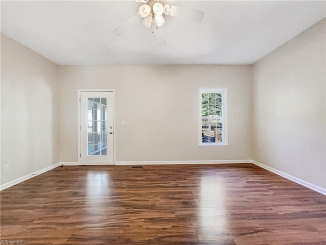 unfurnished room with ceiling fan and dark wood-type flooring