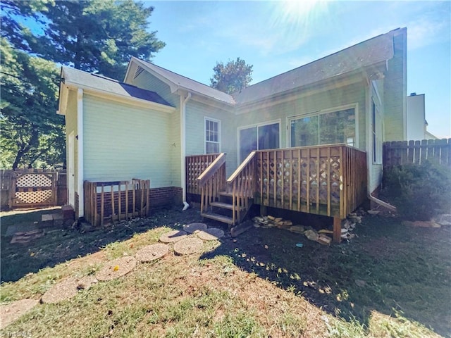 back of house with a deck