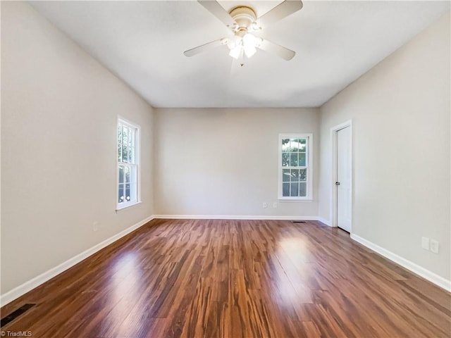 spare room with ceiling fan and dark hardwood / wood-style flooring