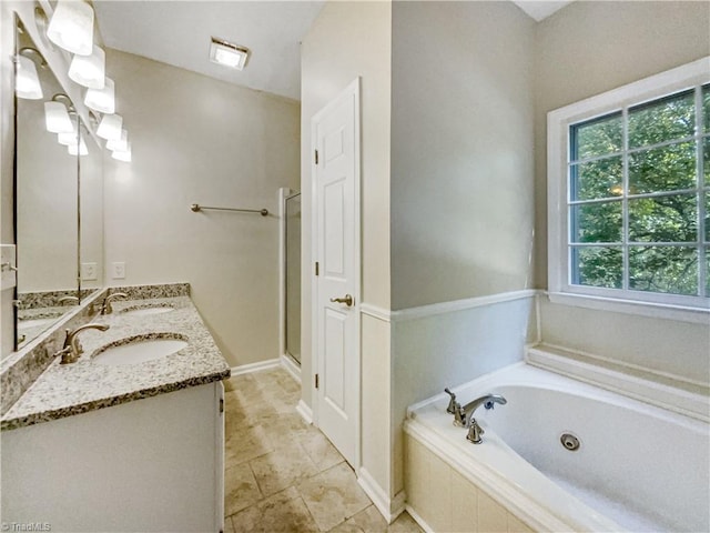 bathroom with vanity and independent shower and bath