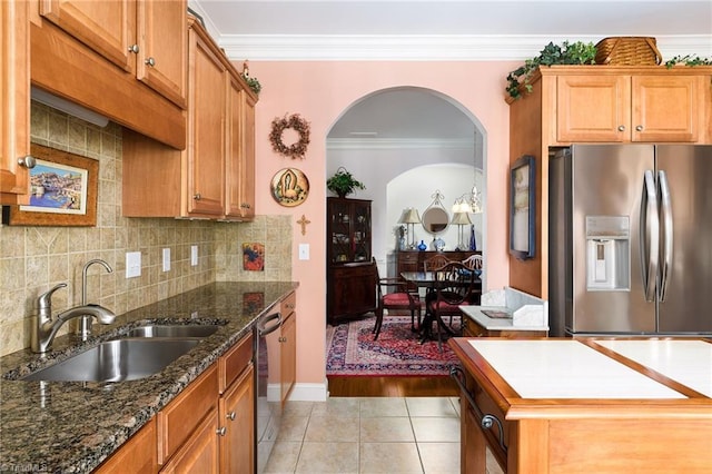 129 Turnbuckle Ct, Clemmons, NC 27012 - kitchen with appliances with stainless steel finishes, light tile patterned floors, arched walkways, crown molding, and backsplash