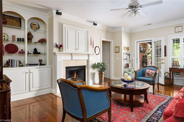 129 Turnbuckle Ct, Clemmons, NC 27012 - living area featuring a ceiling fan, dark wood-type flooring, a tile fireplace, and ornamental molding