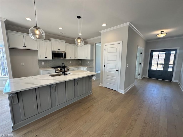 308 Grandworth Way, King, NC 27021 - kitchen featuring stainless steel microwave, a sink, white cabinetry, baseboards, and ornamental molding