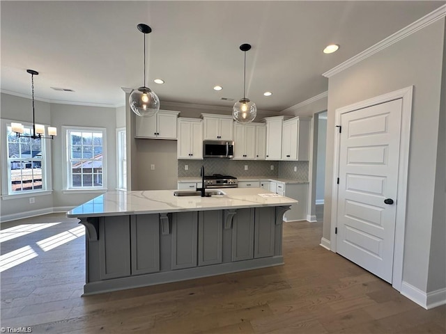 308 Grandworth Way, King, NC 27021 - kitchen featuring appliances with stainless steel finishes, a sink, crown molding, baseboards, and white cabinets