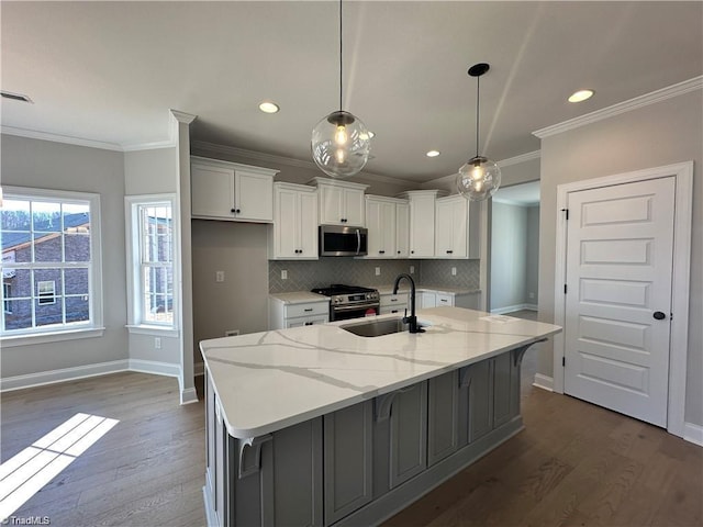 308 Grandworth Way, King, NC 27021 - kitchen featuring appliances with stainless steel finishes, a sink, white cabinetry, ornamental molding, and dark wood finished floors