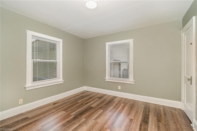 spare room with wood-type flooring