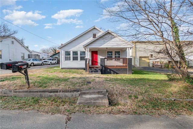 bungalow-style home with a porch and a front lawn